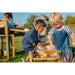 children-playing-with-foam-and-water-at-a-multi-level-wooden-water-run