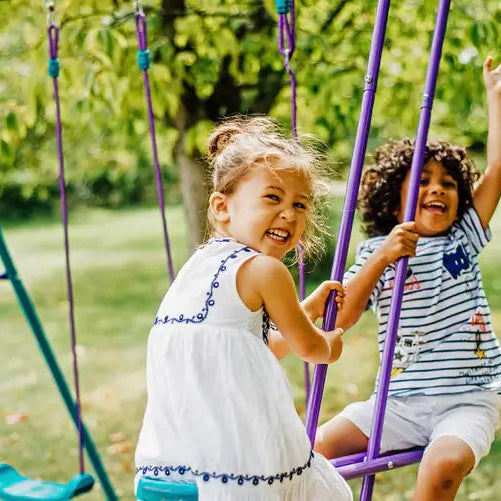 children-smiling-on-plum-jupiter-glider-swing