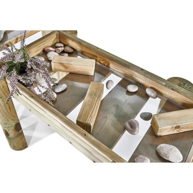 close-up-of-central-water-run-table-with-clear-panels-wooden-diverters-and-stones
