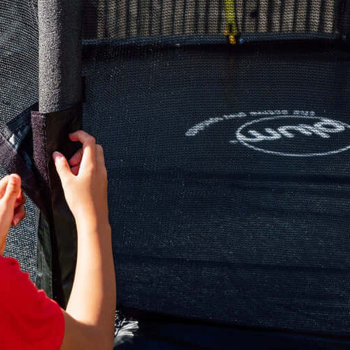 close-up-of-child-fastening-plum-spacezone-trampoline-net-to-pole