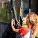 close-up-of-child-fitting-foam-sleeve-on-plum-spacezone-trampoline-pole