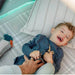 close-up-of-laughing-child-lying-on-cushions-inside-play-tent
