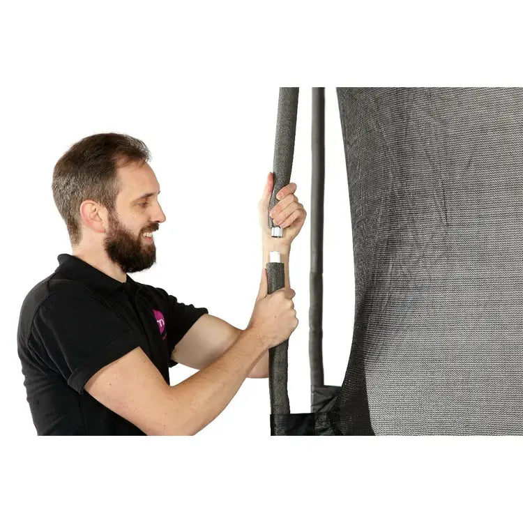 close-up-of-man-fitting-upper-enclosure-pole-on-plum-space-zone-ii-springsafe-trampoline