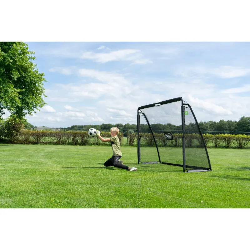 lifestyle-shot-of-exit-coppa-football-goal-playground-setup-with-kid-catching-the-ball