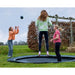 exit-interra-ground-level-trampoline-305cm-with-family-playing-with-bush-in-the-background
