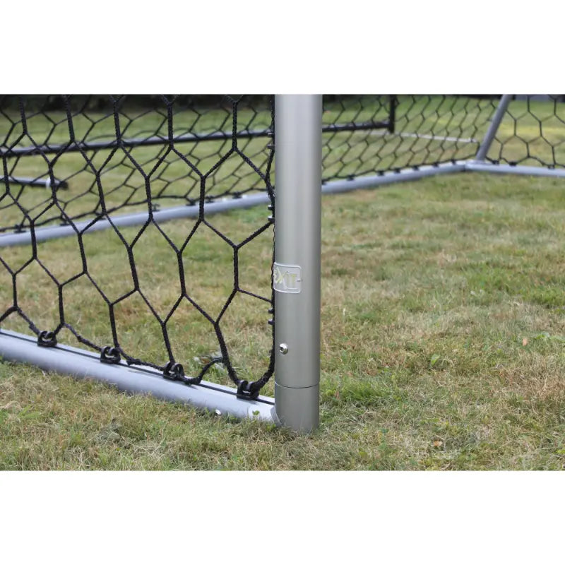 Lifestyle shot of EXIT Scala ground anchors securing the football goal on grass