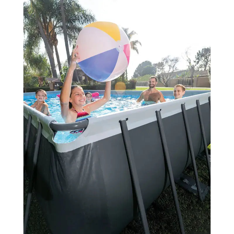Children playing with a beach ball in an above-ground pool