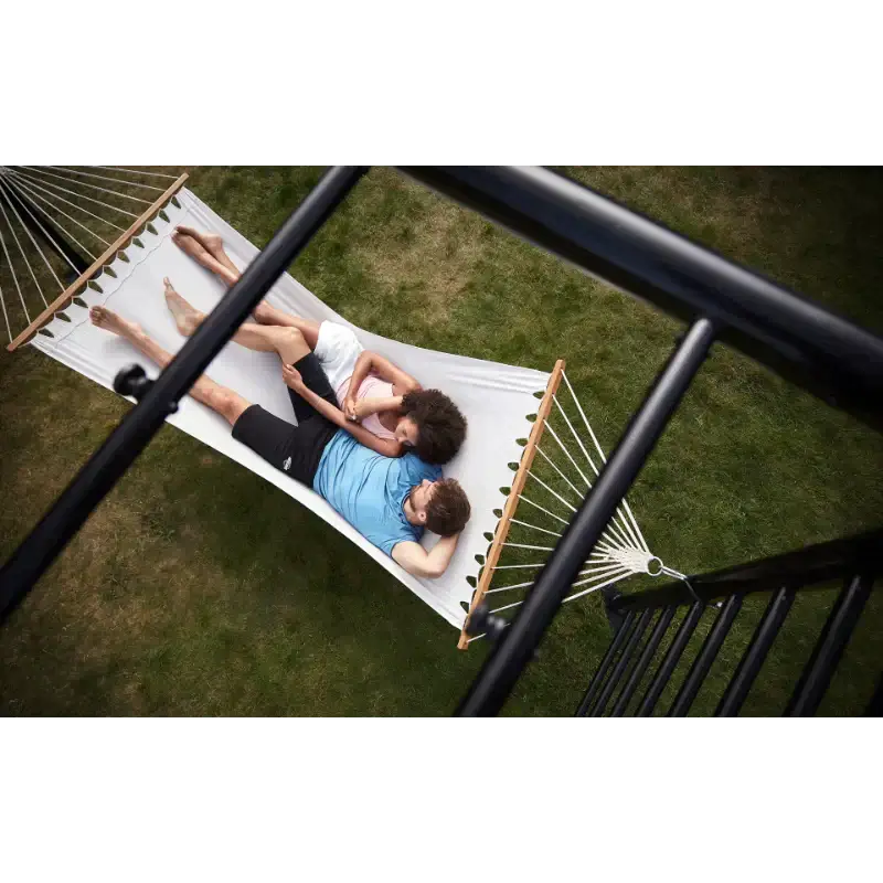 family-lying-together-on-garden-hammock-beneath-black-outdoor-play-frame