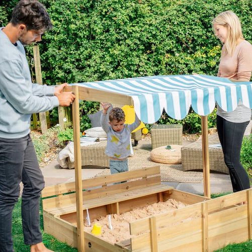 family-raising-shelter-roof-above-childrens-sandpit