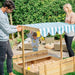 family-raising-shelter-roof-above-childrens-sandpit