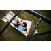 family-relaxing-together-on-hammock-attached-to-outdoor-play-frame-in-garden