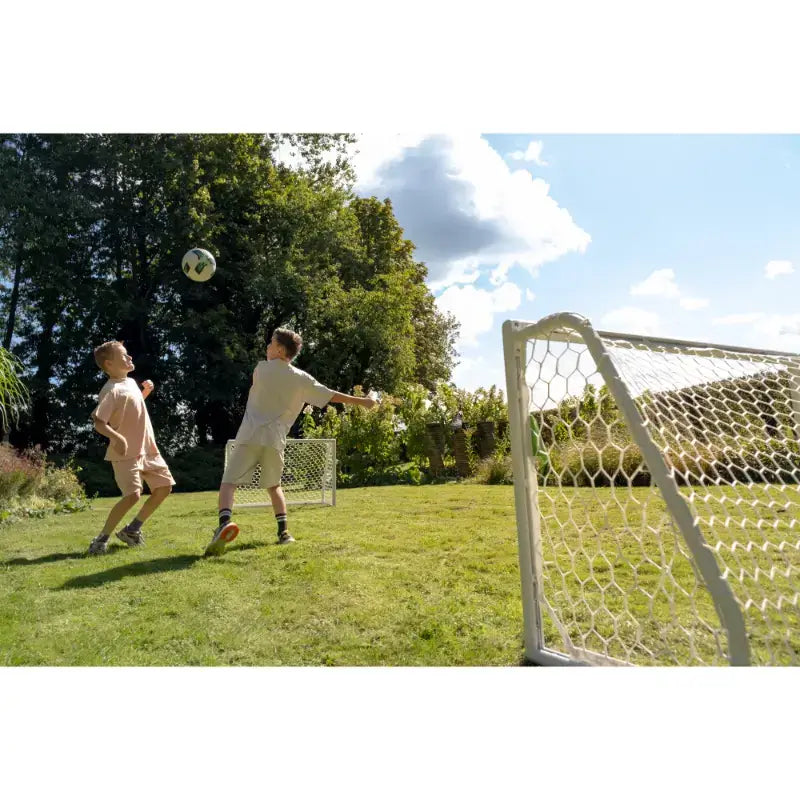 Kids playing football using EXIT Scala white football goal.