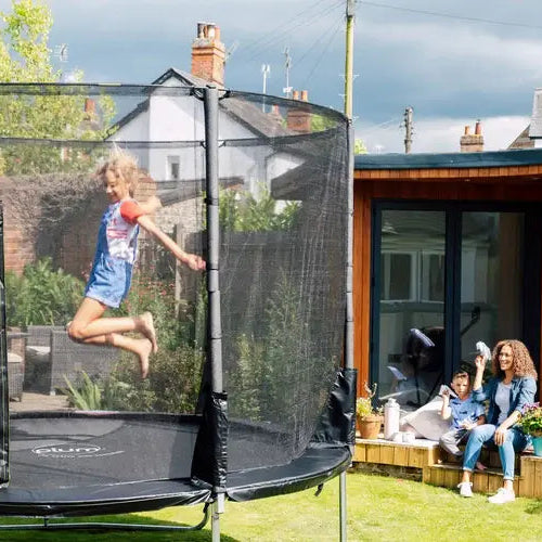 girl-jumping-on-plum-spacezone-ii-evolution-springsafe-trampoline-with-family-watching