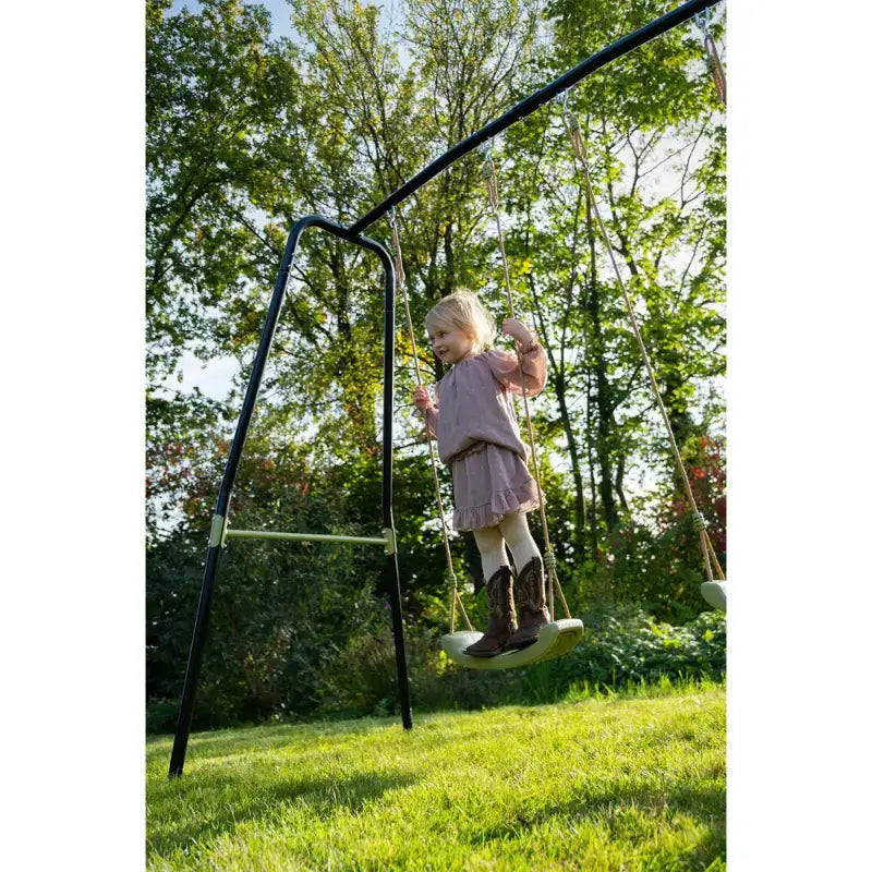 girl-standing-on-the-seat-of-exit-ivy-swing-set
