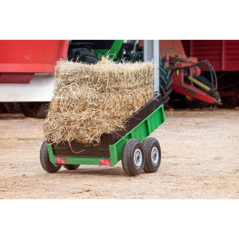 green-farm-trailer-loaded-with-hay-bales-in-a-farmyard