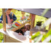 interior-view-of-exit-hika-wooden-outdoor-playhouse-with-children-playing-ice-cream-cake