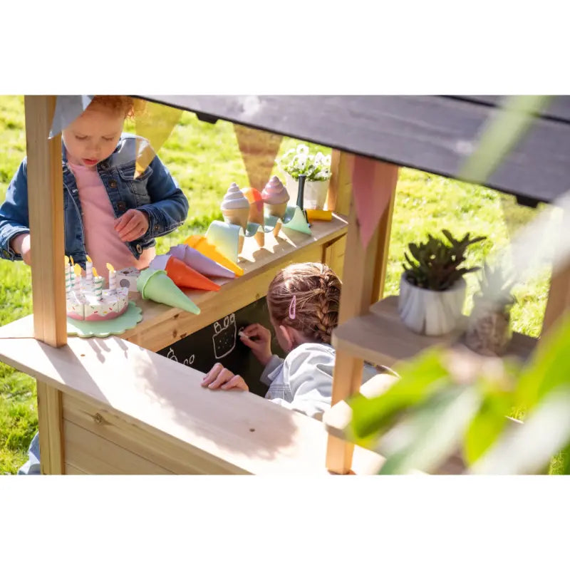 interior-view-of-exit-hika-wooden-outdoor-playhouse-with-children-playing-ice-cream-cake