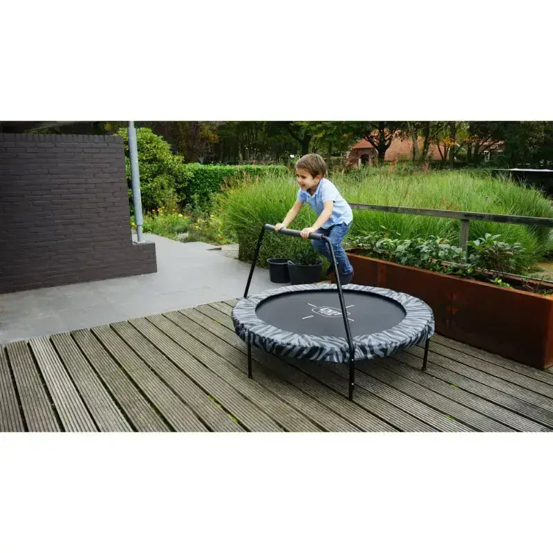 kid-jumping-on-exit-tiggy-junior-trampoline-with-handle-bar