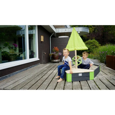 kids-playing-exit-aksent-wooden-sandpit-boat-patio-setup