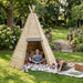 kids-reading-and-exploring-outside-a-timber-tipi-den