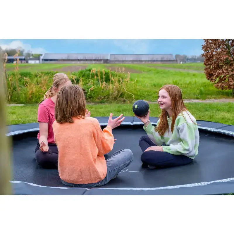 kids-relaxing-and-talking-on-exit-interra-ground-level-trampoline-uk-366cm-black