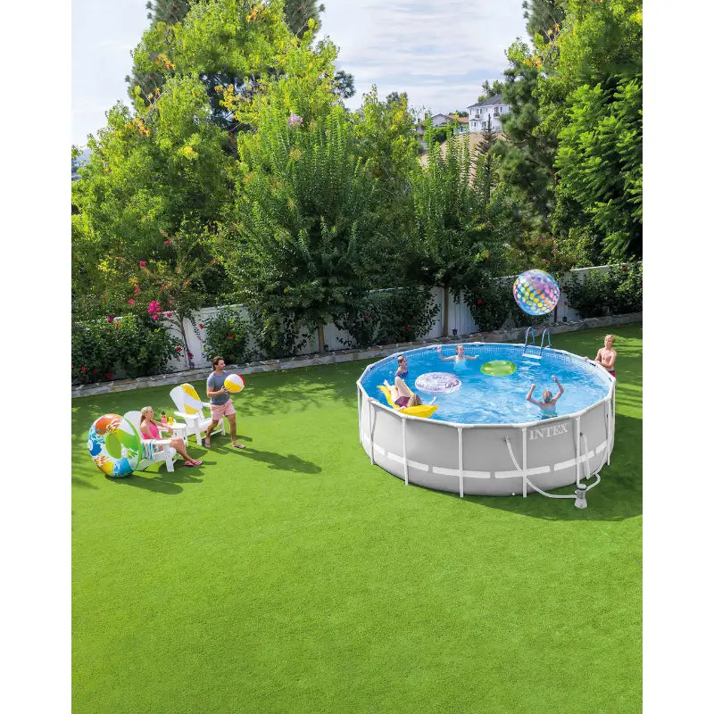 kids-swimming-and-playing-in-intex-easy-set-pool-12x30-placed-on-the-lawn-with-trees-in-the-background