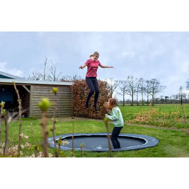 lifestyle-view-of-exit-toys-trampoline-in-ground