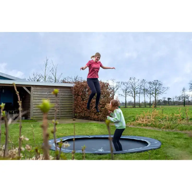lifestyle-view-of-exit-toys-trampoline-in-ground