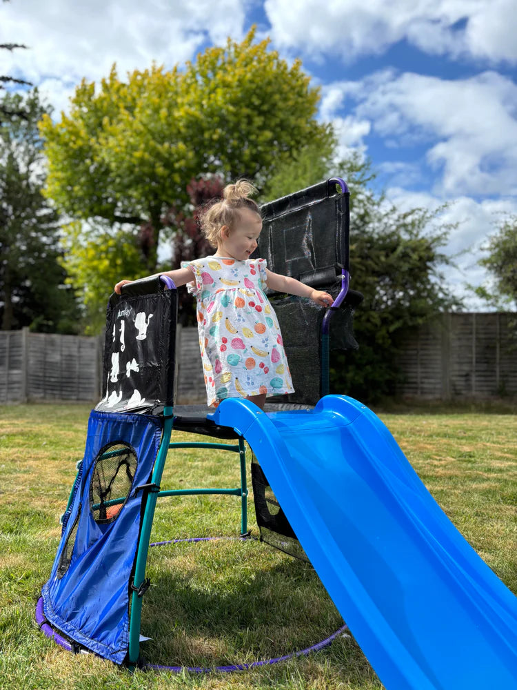 little-girl-at-the-top-of-blue-slide-on-activity-centre