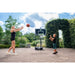 lowered-height-exit-novastar-adjustable-basketball-backboard-outdoor-setup-with-bush-in-the-background