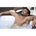 man-relaxing-in-layz-spa-maldives-hot-tub-with-hot-water-bubbles