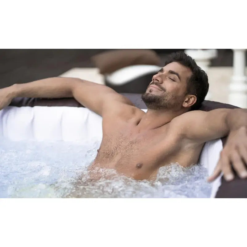 man-relaxing-in-layz-spa-maldives-hot-tub-with-hot-water-bubbles