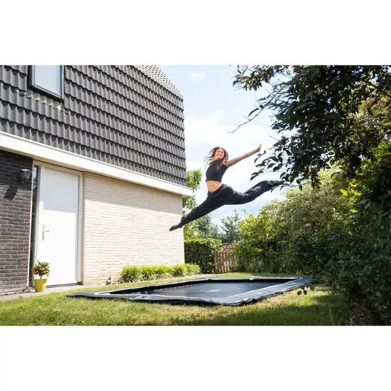 mid-air-shot-of-woman-with-exit-ground-level-trampoline-UK