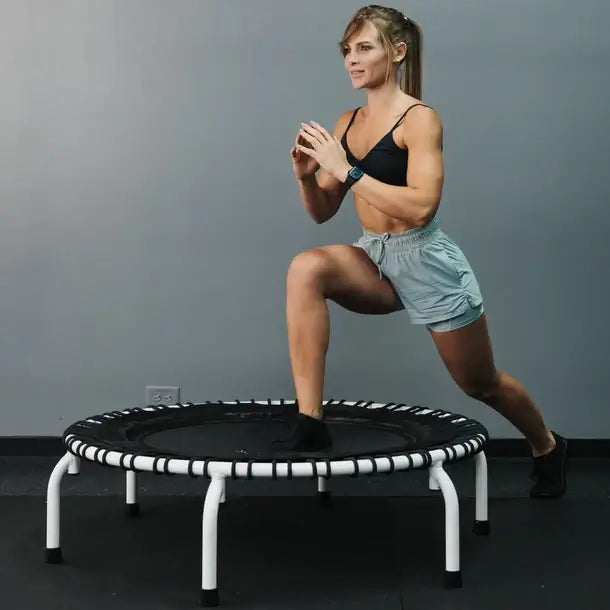 woman-stretching-on-mini-550-jumpsport-rebounder-white-version