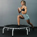 woman-stretching-on-mini-550-jumpsport-rebounder-white-version