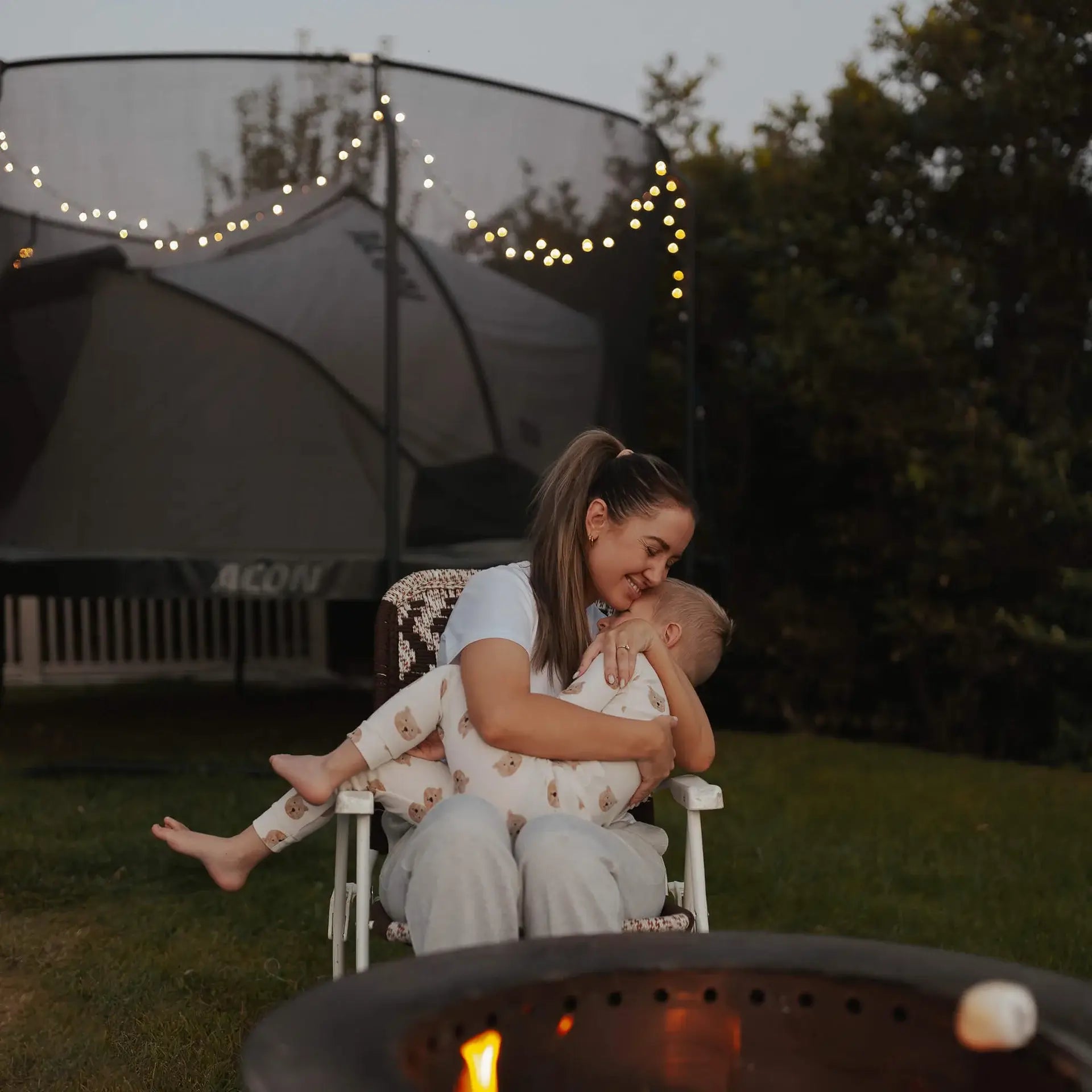 mother-and-child-with-the-acon-trampoline-tent-in-the-background-with-bulb-lights