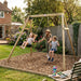 mum-pushing-two-children-on-a-timber-swing-frame-over-bark-play-area