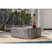 neutral-marble-effect-lazy-spa-rome-hot-tub-with-woman-sitting-on-rim