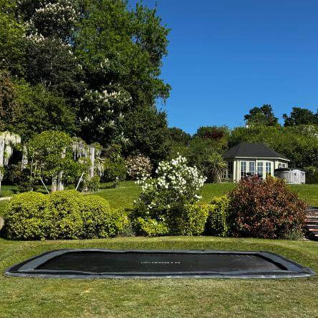 north-17ft-x-12ft-rectangular-inground-trampoline-installed-in-landscaped-garden