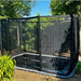 north-inground-trampoline-with-safety-net-beside-garden-wall