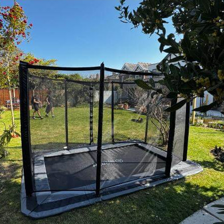 north-rectangular-inground-trampoline-with-safety-enclosure-in-back-garden