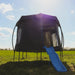 outdoor-trampoline-with-enclosure-tent-and-blue-slide-in-sunny-field