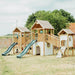 plum-large-wooden-climbing-frame-with-three-towers-double-slide-bridge-and-swings-lifestyle
