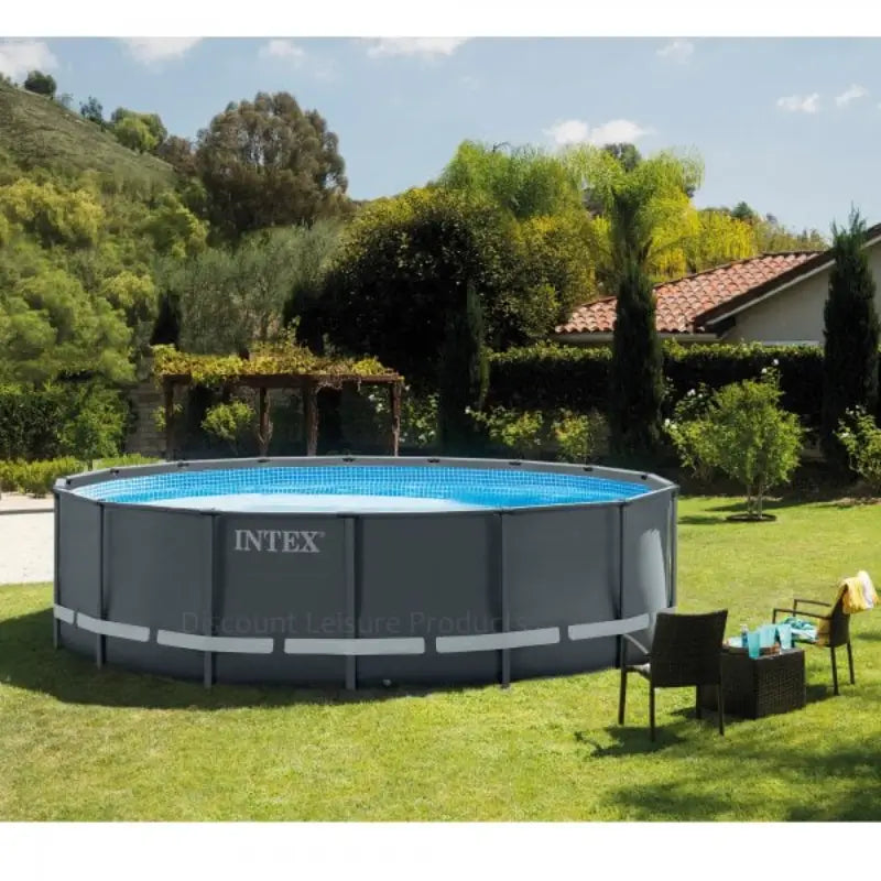 overview-of-round-intex-ultra-xtr-16x48-pool-set-with-trees-in-the-background-and-a-comfortable-sitting-area