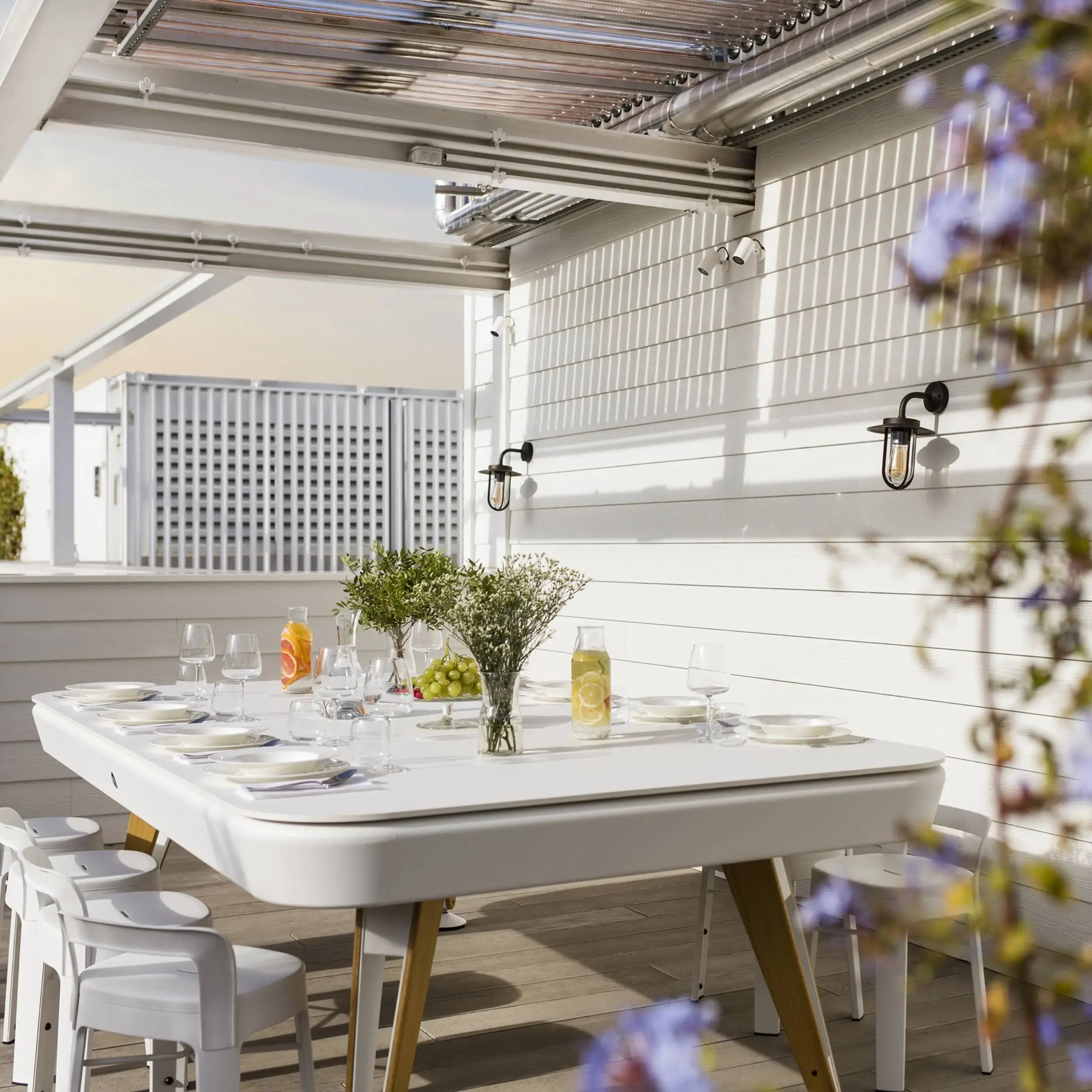 rs-barcelona-diagonal-outdoor-pool-dining-table-lifestyle-shot-with-flower-vases-and-plates-setup-for-dining