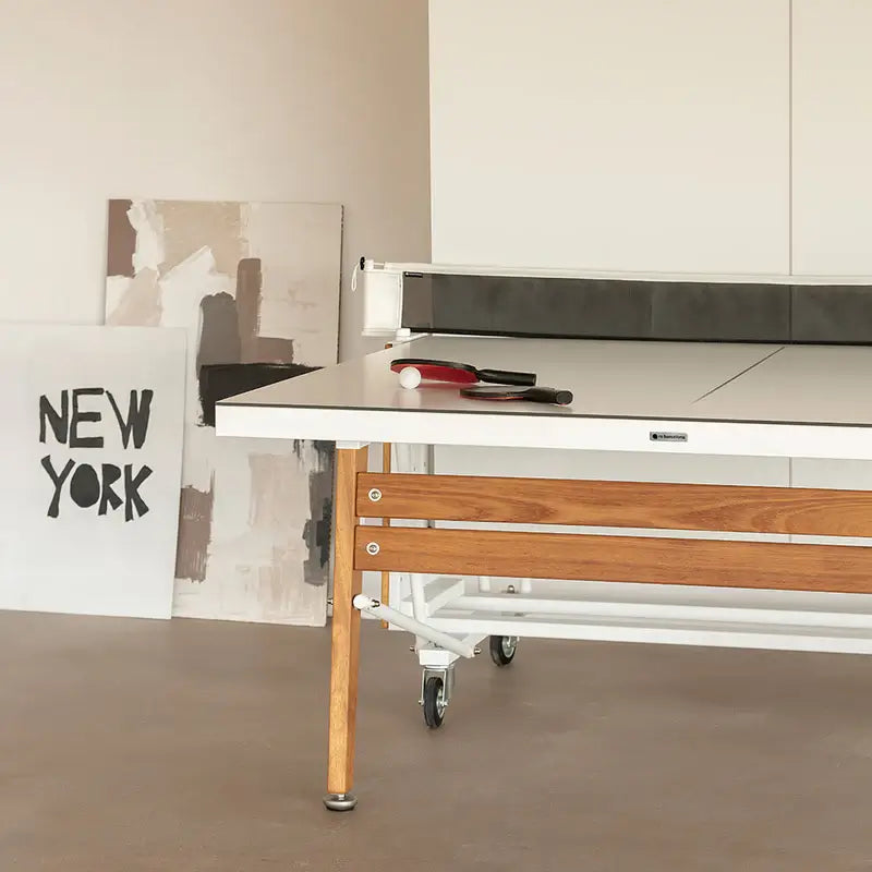 partial-view-of-rs-barcelona-folding-ping-pong-table-on-wheels-with-paintings-in-background-left