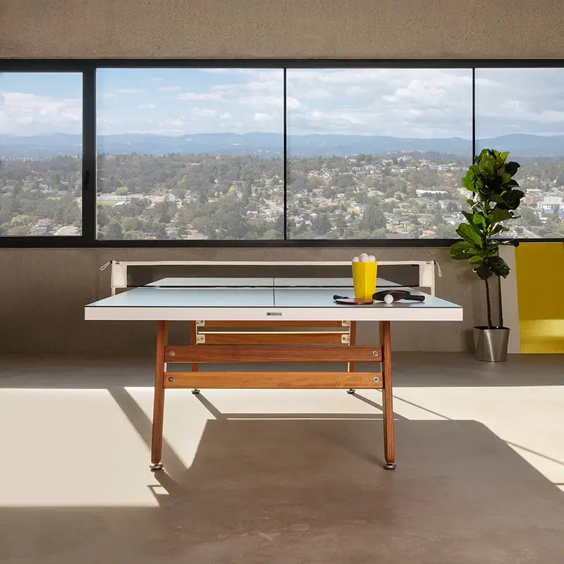 side-view-of-indoor-barcelona-stationary-ping-pong-table-showing-the-legs-and-net-in-place-with-town-view-in-the-background