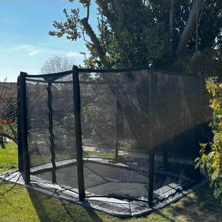 side-view-of-north-rectangular-inground-trampoline-with-black-safety-net