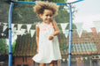 smiling-girl-standing-in-blue-enclosed-trampoline