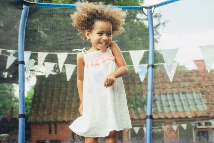 smiling-girl-standing-in-blue-enclosed-trampoline